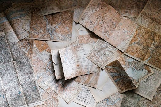 A collection of vintage maps scattered for exploring world journeys and discoveries.